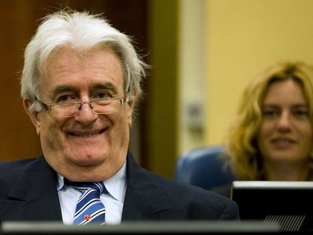 Radovan Karadzic smiles as he starts his defence at the UN war crimes tribunal