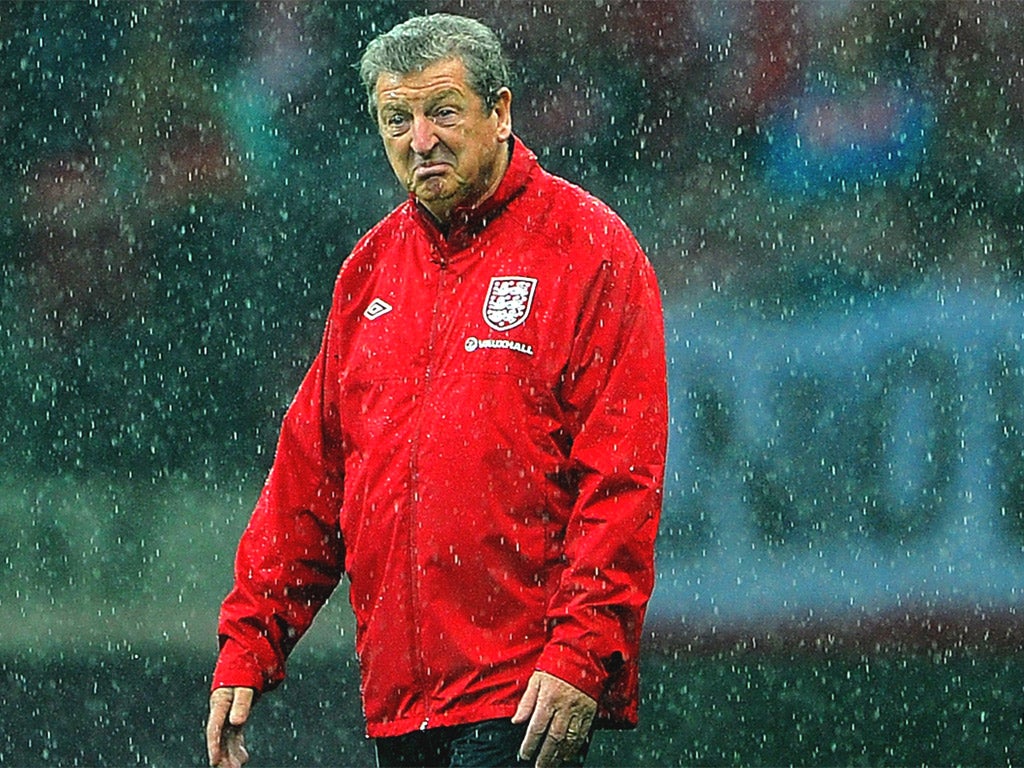 Roy Hodgson inspects the pitch at the National Stadium in Warsaw