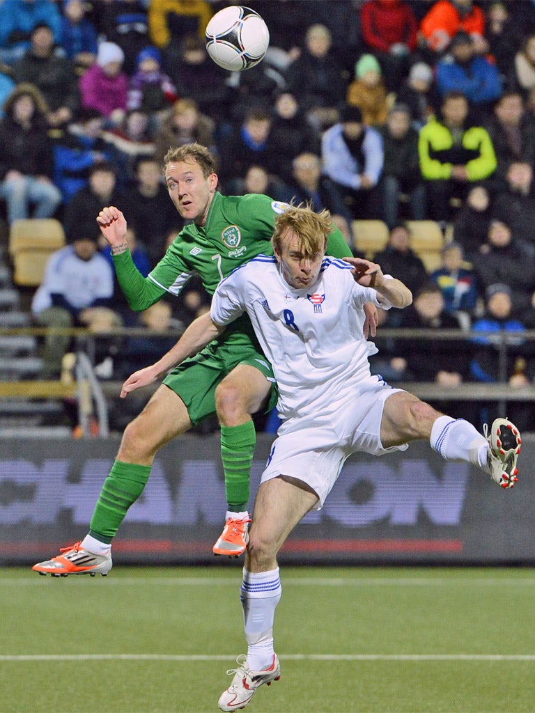 Aiden McGeady battles for the ball with Simun Samuelsen