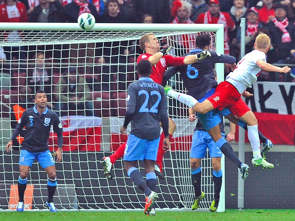 Kamil Glik rises above the England defence to head in Poland's equaliser