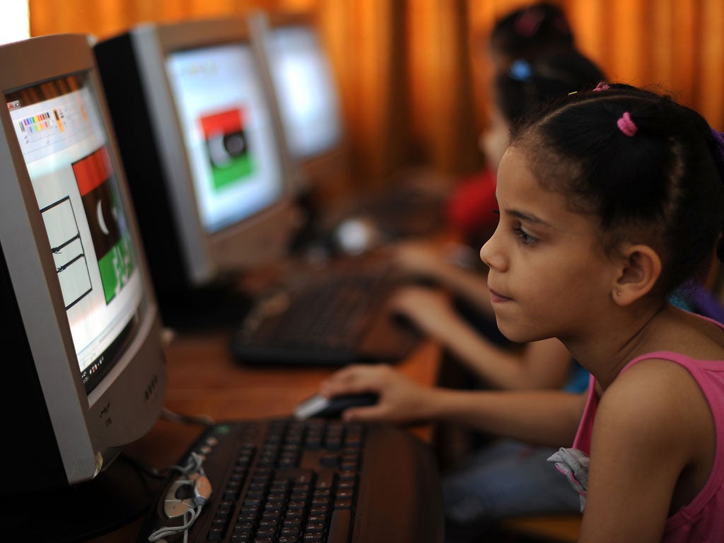 A Libyan girl uses a computer at a school organised by volunteers, Benghazi on June 1, 2011