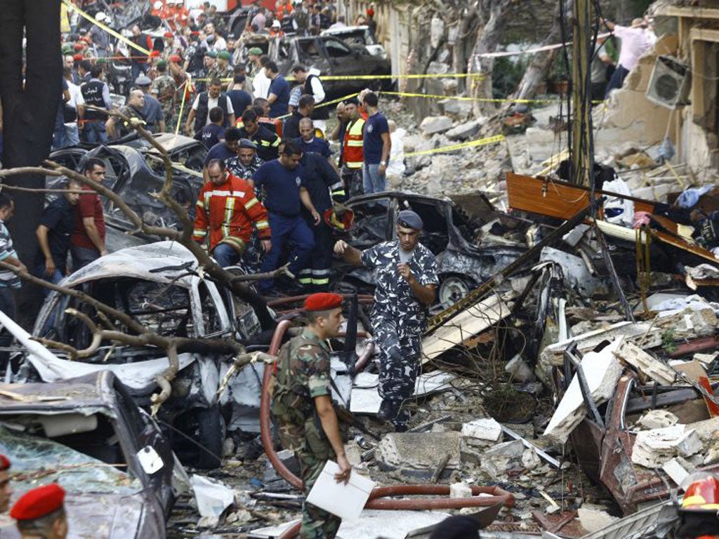 Lebanese soldiers walk amidst the rubble