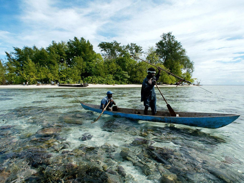 Pure shores: Fishermen paddle off from Kennedy Island