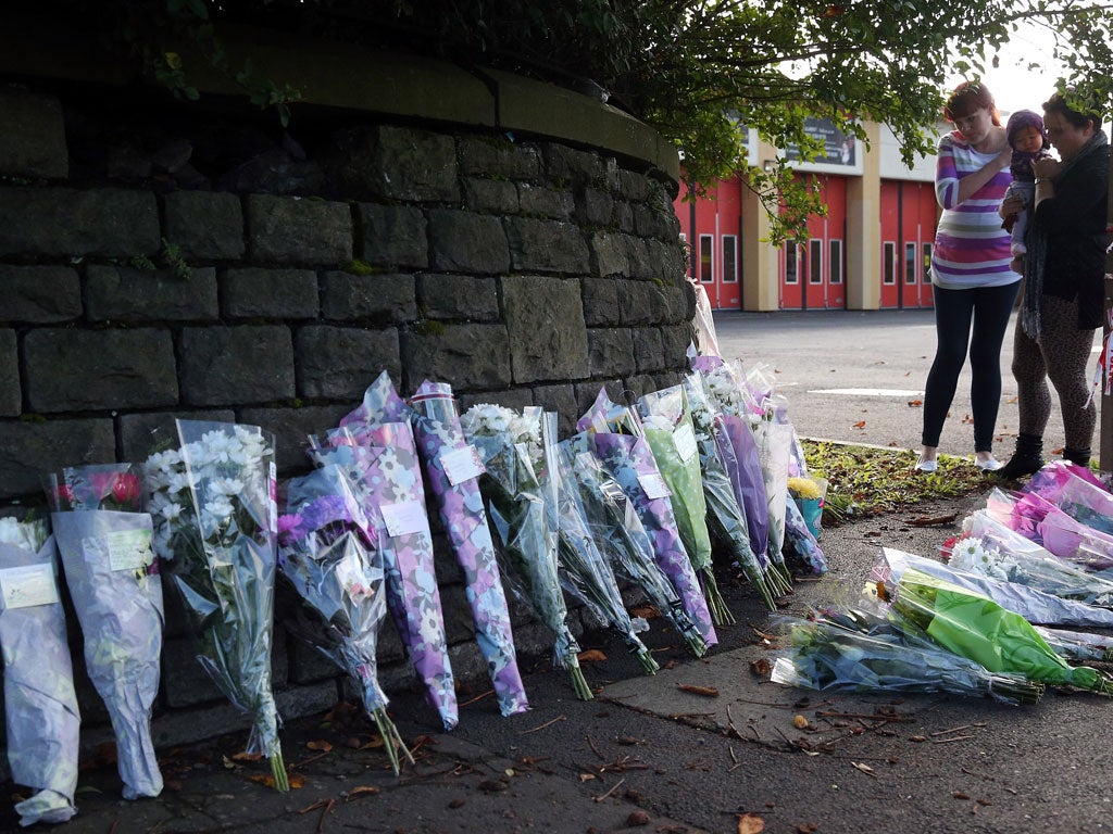 Flowers left at the spot next to Ely fire station, Cardiff, where Karina Menzies was killed on Friday