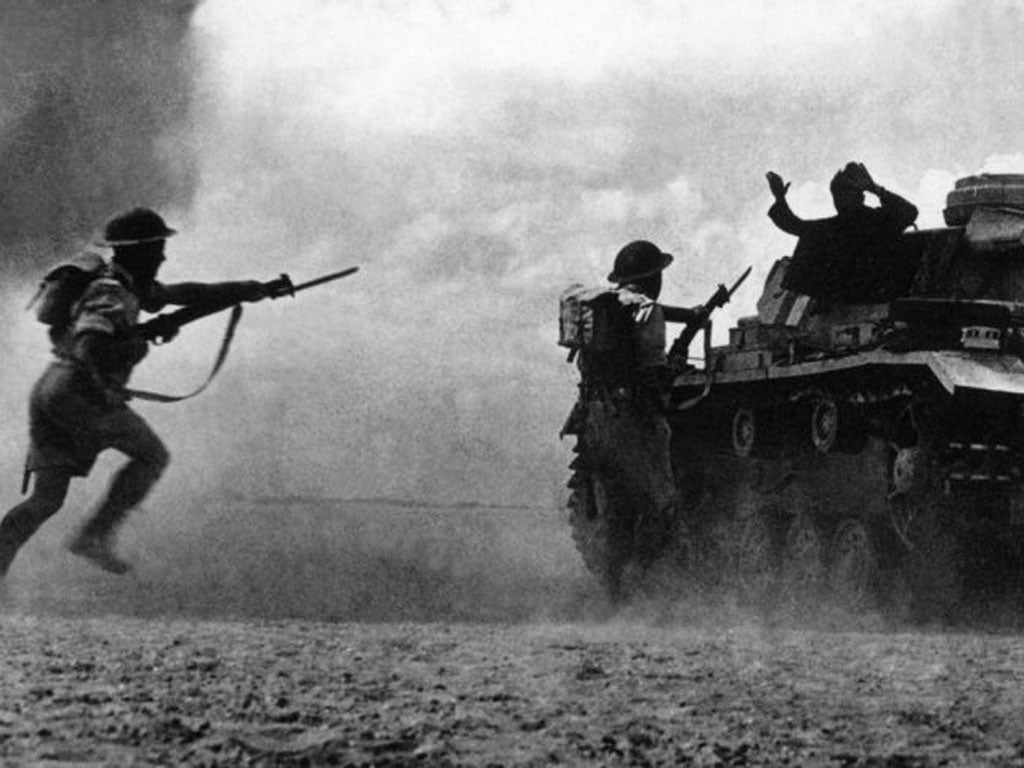 Allied soldiers capture a German tank in 1942