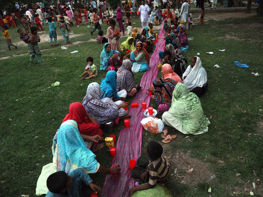 Pakistani Muslim women break their fast at a park in Lahore on July 21, 2102, on the first day of the month of Ramadan.