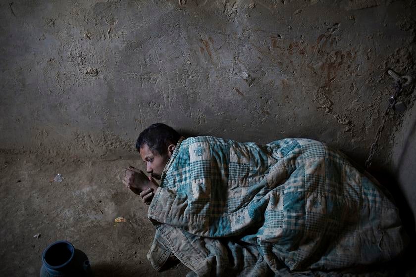 AFGHAN MENTAL: A Kandahari man stays in cell No. 5 of the Mia Ali Sahib shrine in Jalalabad, Afghanistan. No one at the shrine knows his name. Photo for The Washington Post by Mikhail Galustov