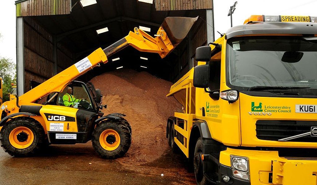 A gritting truck is loaded with a stockpile of salt and molasses mixture used for road gritting at the Northern Highway Depot, Mountsorrel, Leicestershire