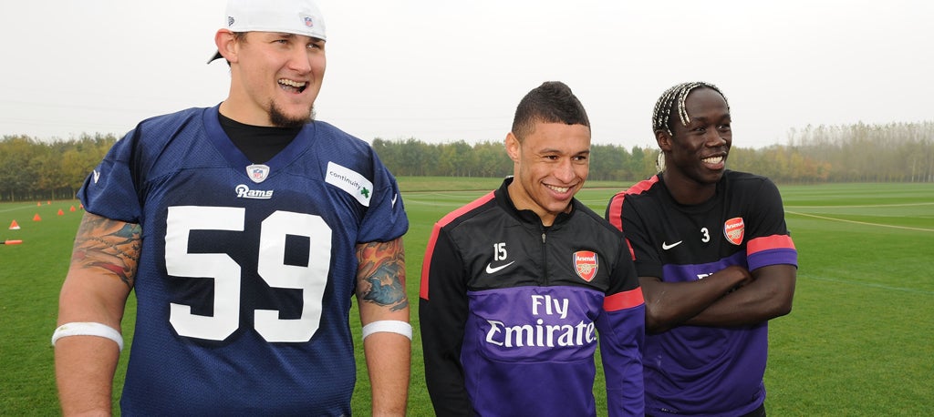 Bacary Sagna and Alex Oxlade-Chamberlain of Arsenal pictured training with Rob Turner of the St Louis Rams earlier today to promote the weekend's NFL game at Wembley