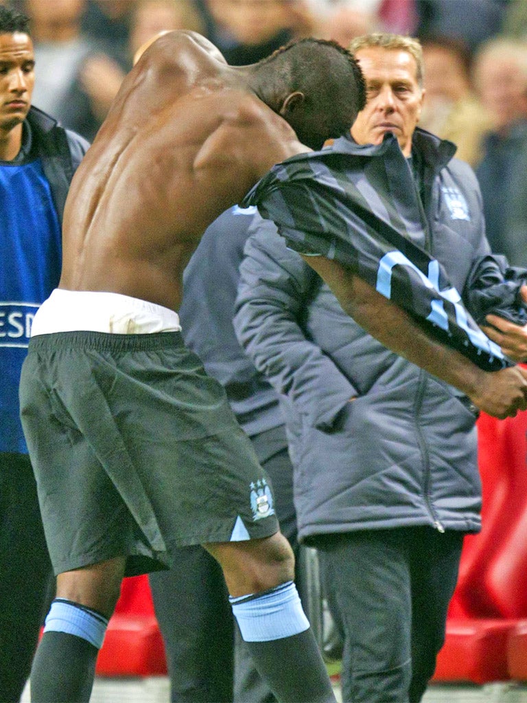 Mario Balotelli, who was a substitute, rips off his shirt