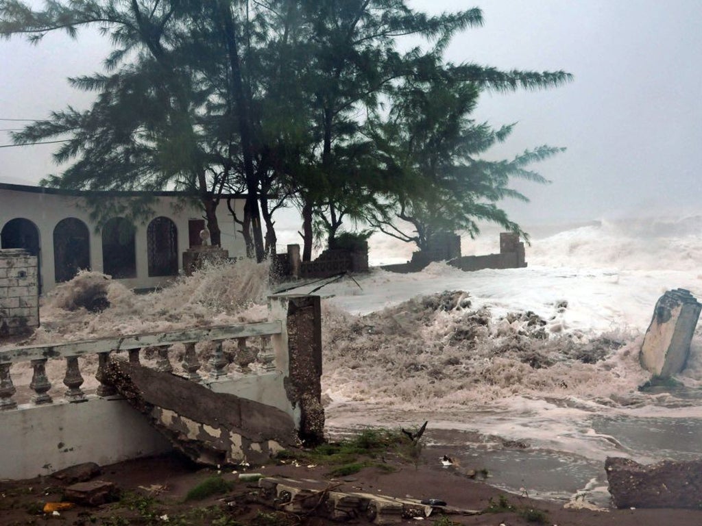 Waves from the hurricane hit a house in Kingston