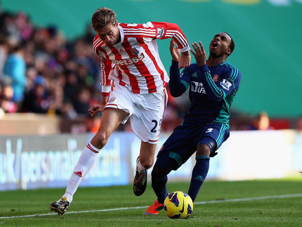 Peter Crouch of Stoke and Danny Rose of Sunderland challenge for the ball