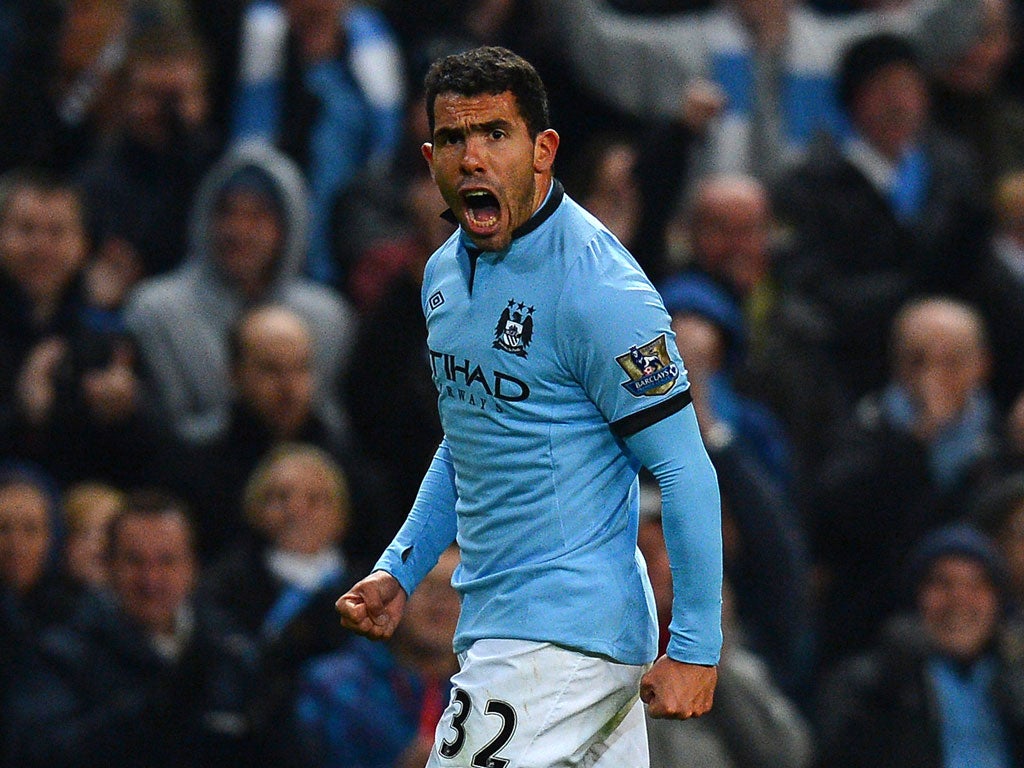 Manchester City's Argentinian striker Carlos Tevez celebrates after scoring the opening goal