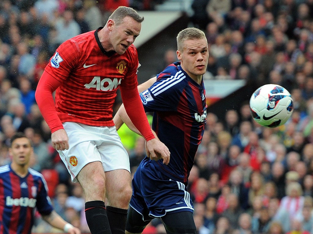 Up in the air: Wayne Rooney scores against Stoke last week but the United striker is unsure what position he will be asked to play today