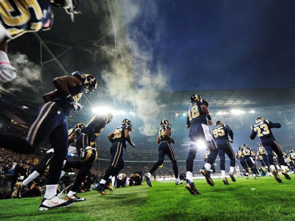 St.Louis Rams run out on the field prior to the NFL International Series match against the New England Patriots