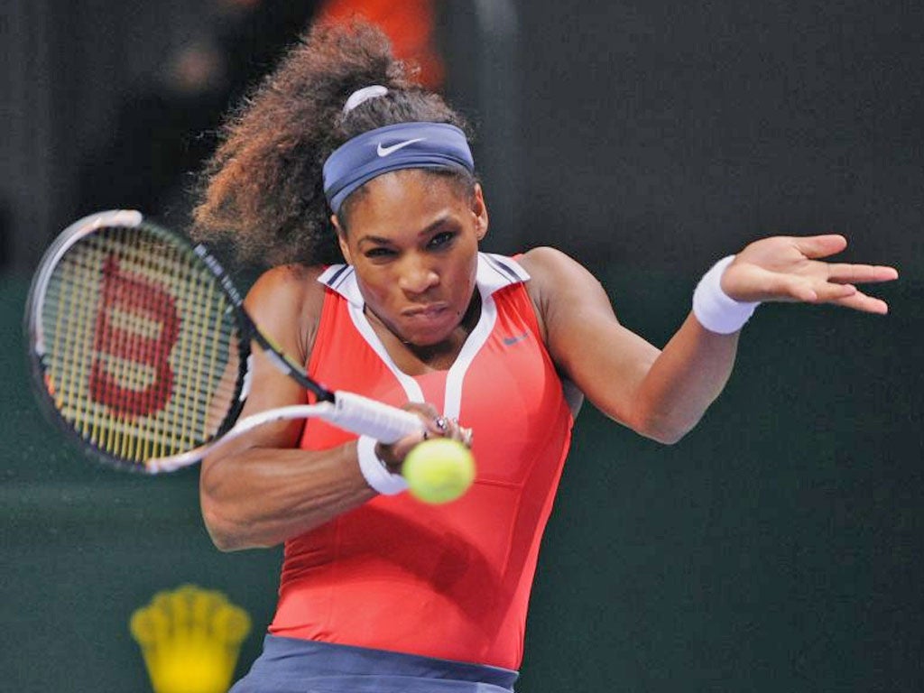 Serena Williams returns a shot to Maria Sharapova during their final tennis match of the WTA Championships in Istanbul