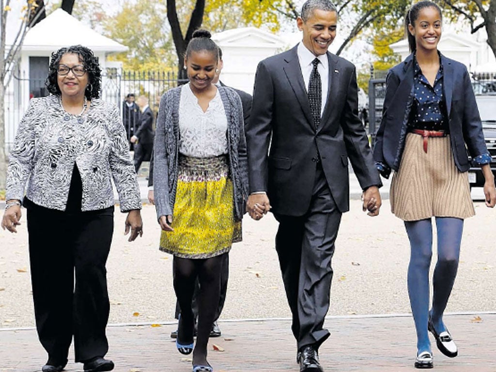 Barack Obama heads to church in Washington yesterday with his
daughters Malia, right, and Sasha, and their godmother, Kaye Wilson