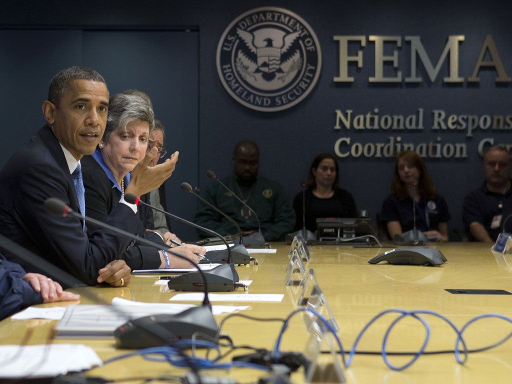 President Barack Obama, accompanied by Homeland Security Secretary Janet Napolitano, second from left, speaks about superstorm Sandy during a visit to the Federal Emergency Management Agency HQ in Washington