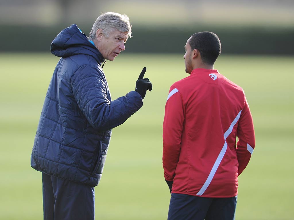 Theo Walcott takes instructions from Arsene Wenger