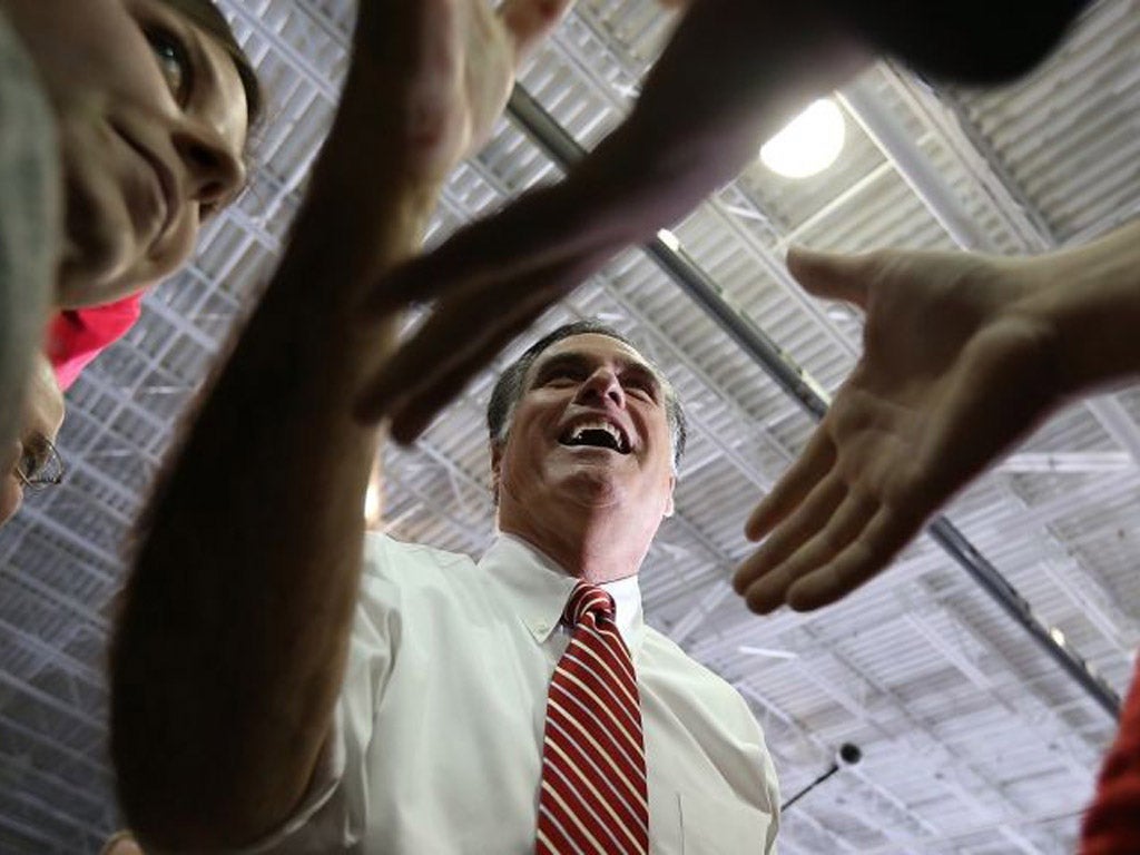 Mitt Romney greets supporters during a campaign event in Virginia