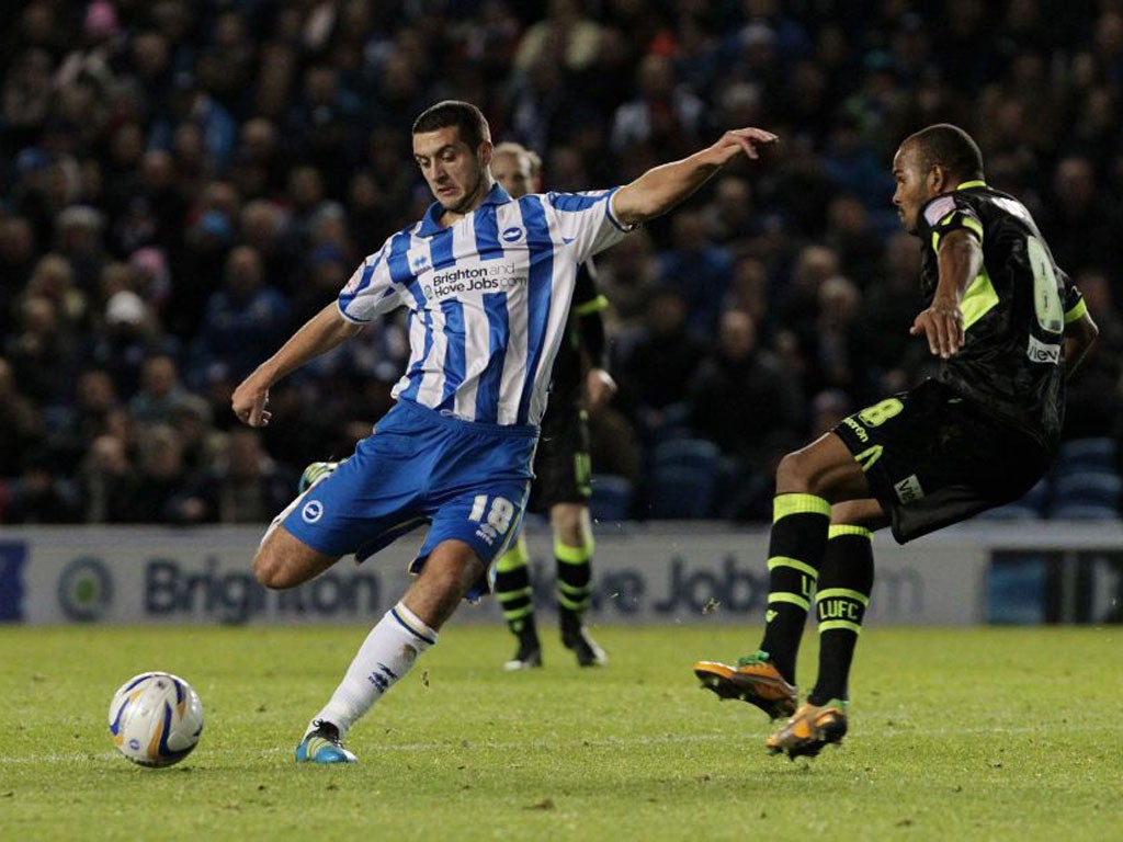 Gary Dicker of Brighton tries to shoot around Leeds midfielder Rodolph Austin