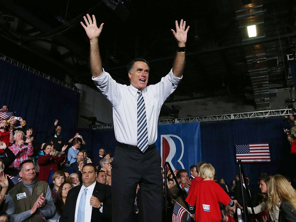 Republican presidential candidate, former Massachusetts Gov. Mitt Romney greets supporters during a campaign rally at the Hy Vee Center in Des Moines, Iowa