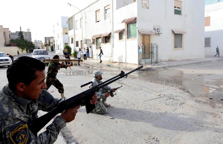 Libyan state security forces known as the National Mobile Forces fire to disband clashes between armed groups near Zawiya street in the Libyan capital, Tripoli