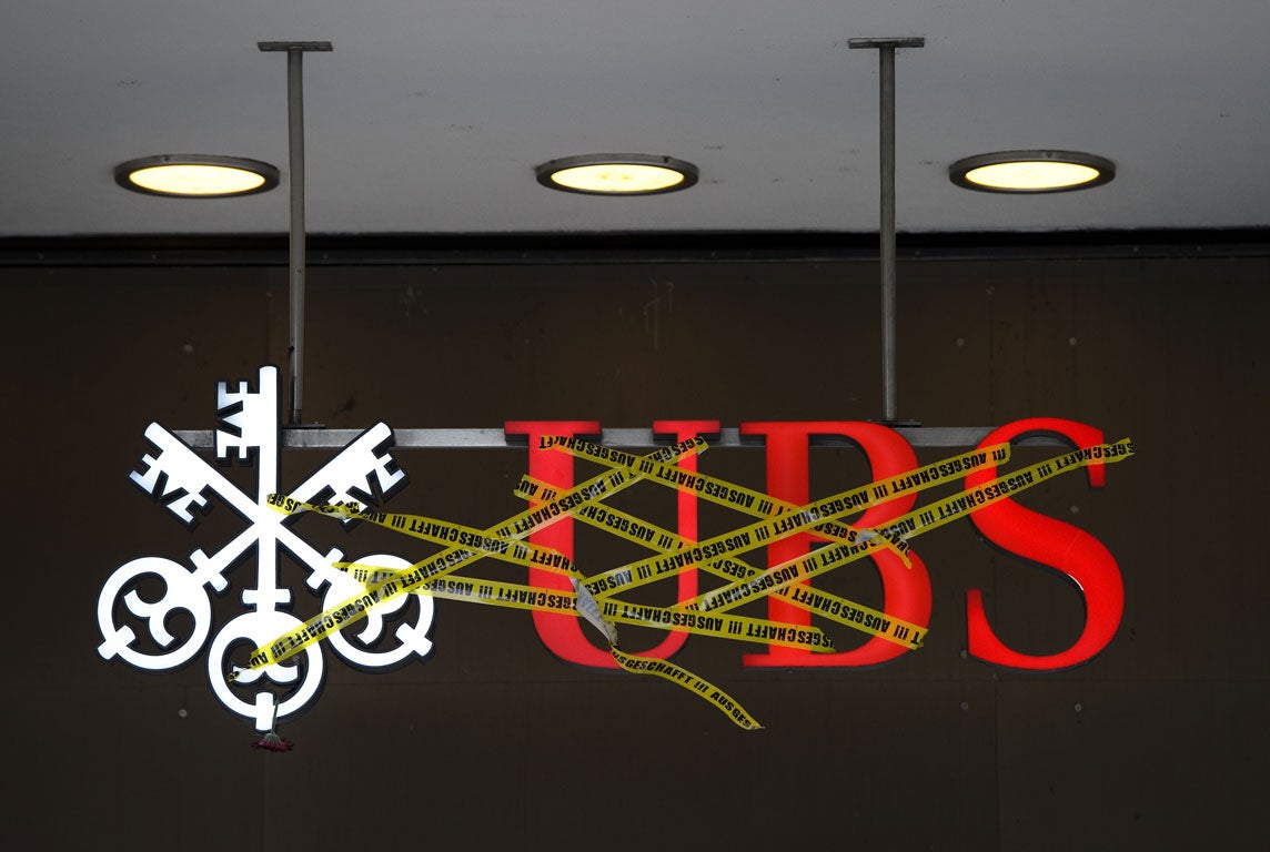 The logo of Swiss banking giant UBS is covered with tape, reading in German: 'Deported!!!' in Zurich on October 15, 2011 during a protest as part of a global day of protests inspired by the 'Occupy Wall Street' and 'Indignant' movements against the bankin