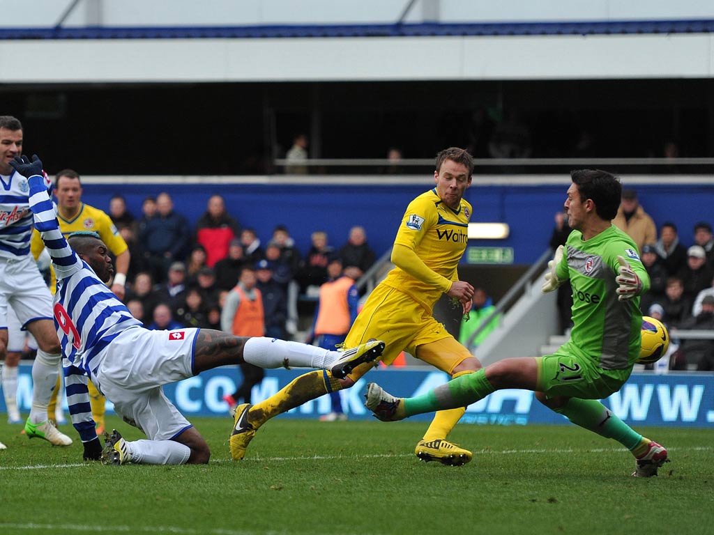 Queens Park Rangers striker Djibril Cisse scores their an equaliser past Reading goalkeeper Alex McCarthy