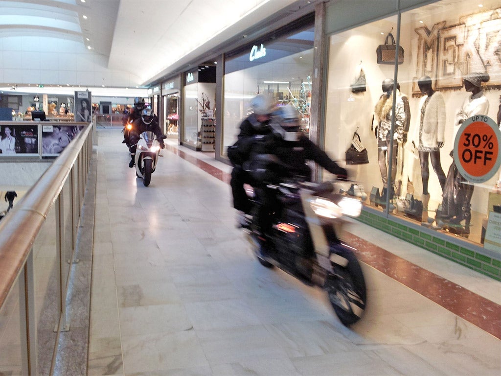 The gang of robbers make their getaway on motorcycles