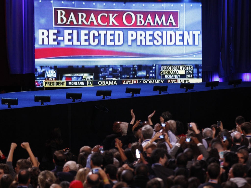 Barack Obama supporters cheer the news of the president's apparent re-election during his election night rally in Chicago