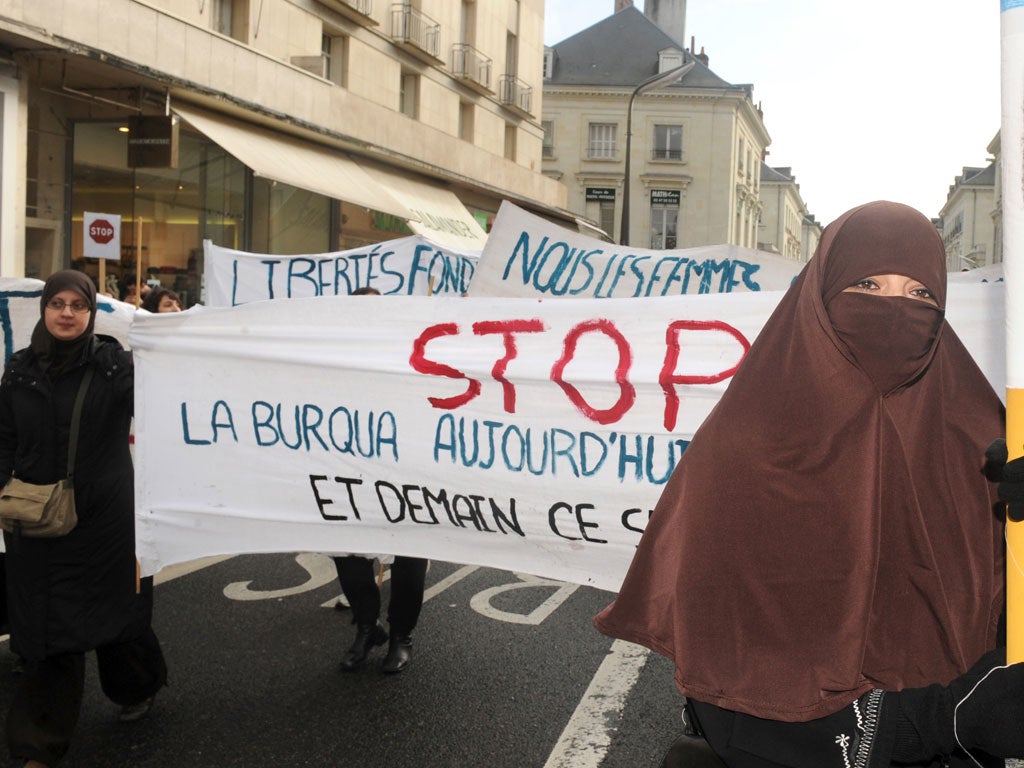 A woman wearing a 'Niqab' veil participates in a protest on February 6, 2010 in Tours, central France, after a panel of French lawmakers recommended a ban on the face-covering veil in all schools, hospitals, public transport and government offices.