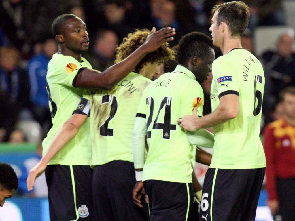 Shola Ameobi (left) celebrates with teammates after scoring his team's second goal