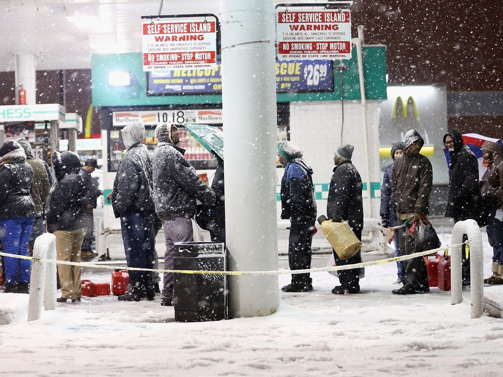 New Yorkers queue for fuel after snow and rain lashed large swathes of America’s East Coast