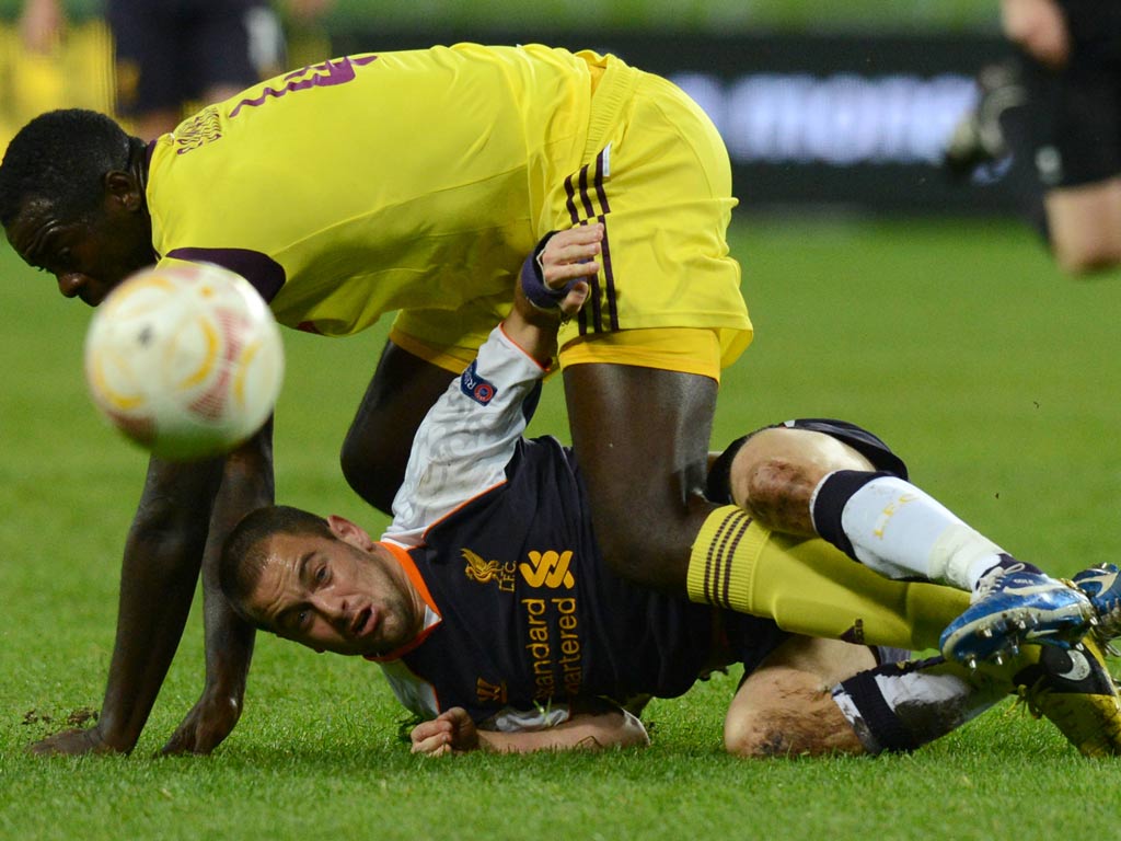 Joao Carlos vies for the ball with Liverpool's Joe Cole