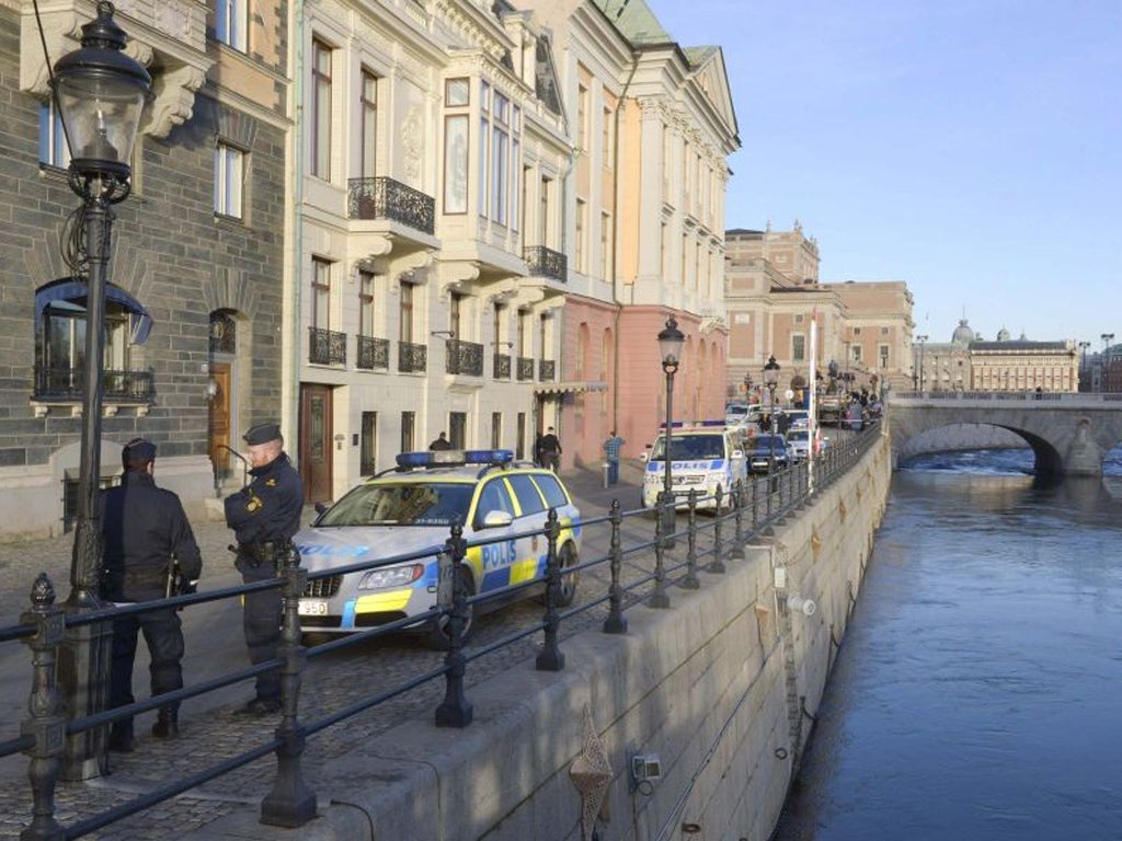 Police officers gather outside the Sagerska Palace, the residence of Swedish Prime Minister Fredrik Reinfeldt, in central Stockholm