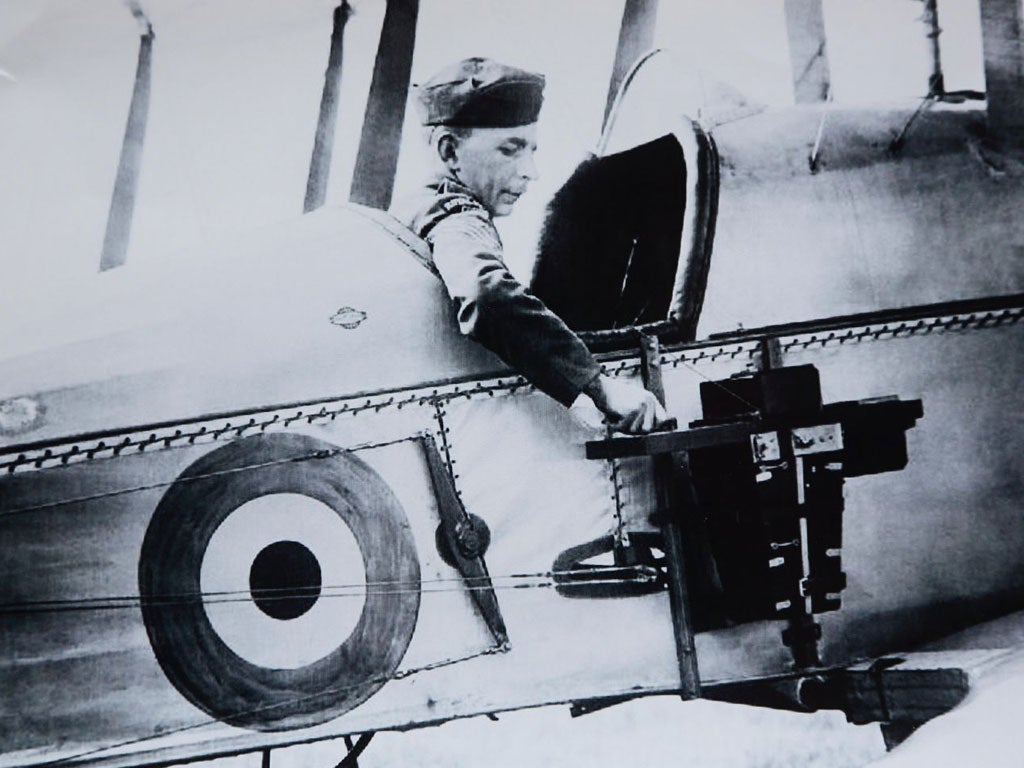 A Royal Flying Corps pilot adjusts his camera. Below: an aerial photo of German and British trenches