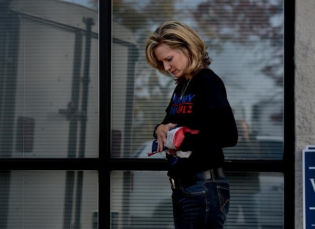 TENNESSEE: Beth Cox folds a small American flag that flew outside the Sumner County, Tenn., Republican headquarters. It was her duty to close the place up and clean it out. Here in the heart of Red America, Cox and many others spent last week grieving not only for themselves and their candidate but also for a country they now believe has gone wildly off track.