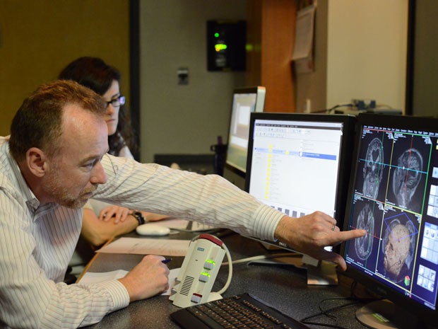 Professor Adrian Owen looking at images in the MRI scanner