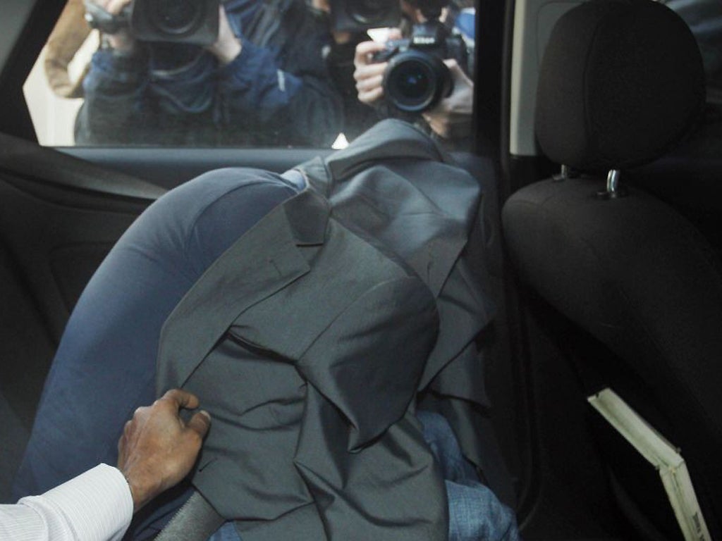 A March 2012 photograph of Edward Devenney covering himself up as he arrives at Westminster Magistrates Court