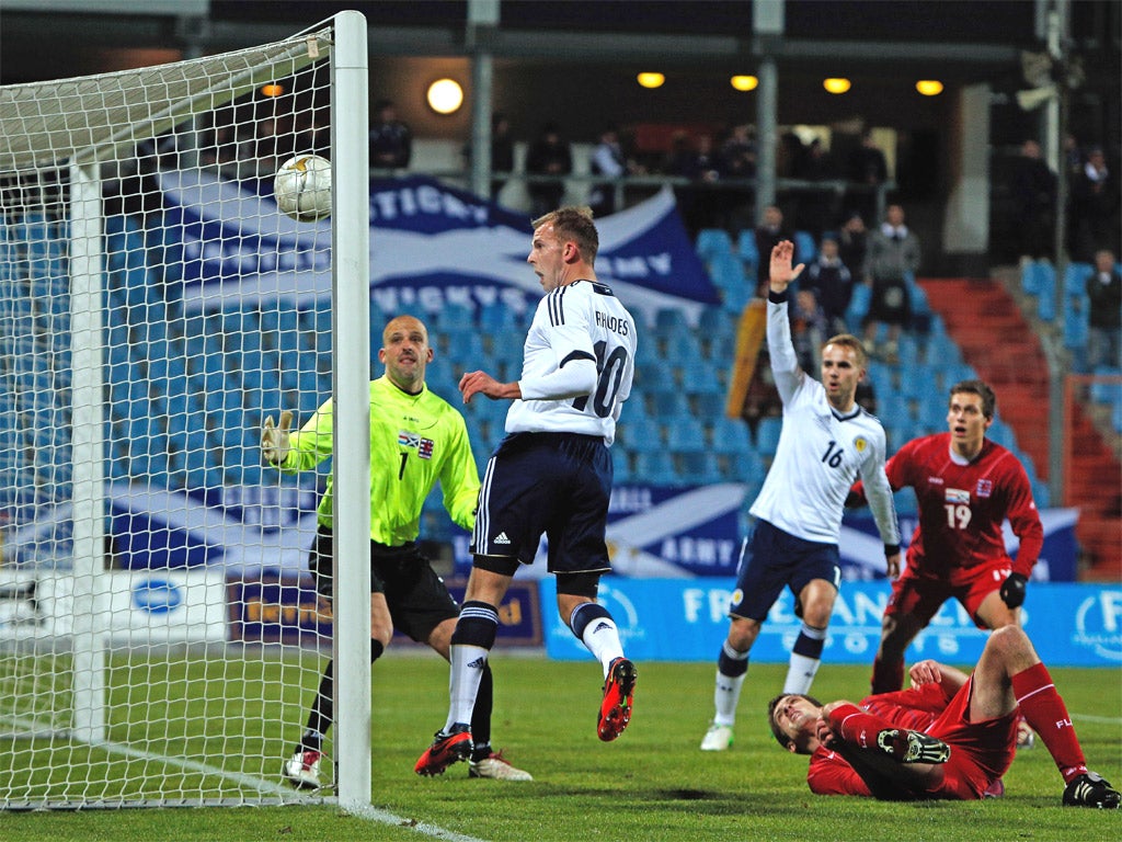 Jordan Rhodes heads in his opening goal for Scotland against Luxembourg