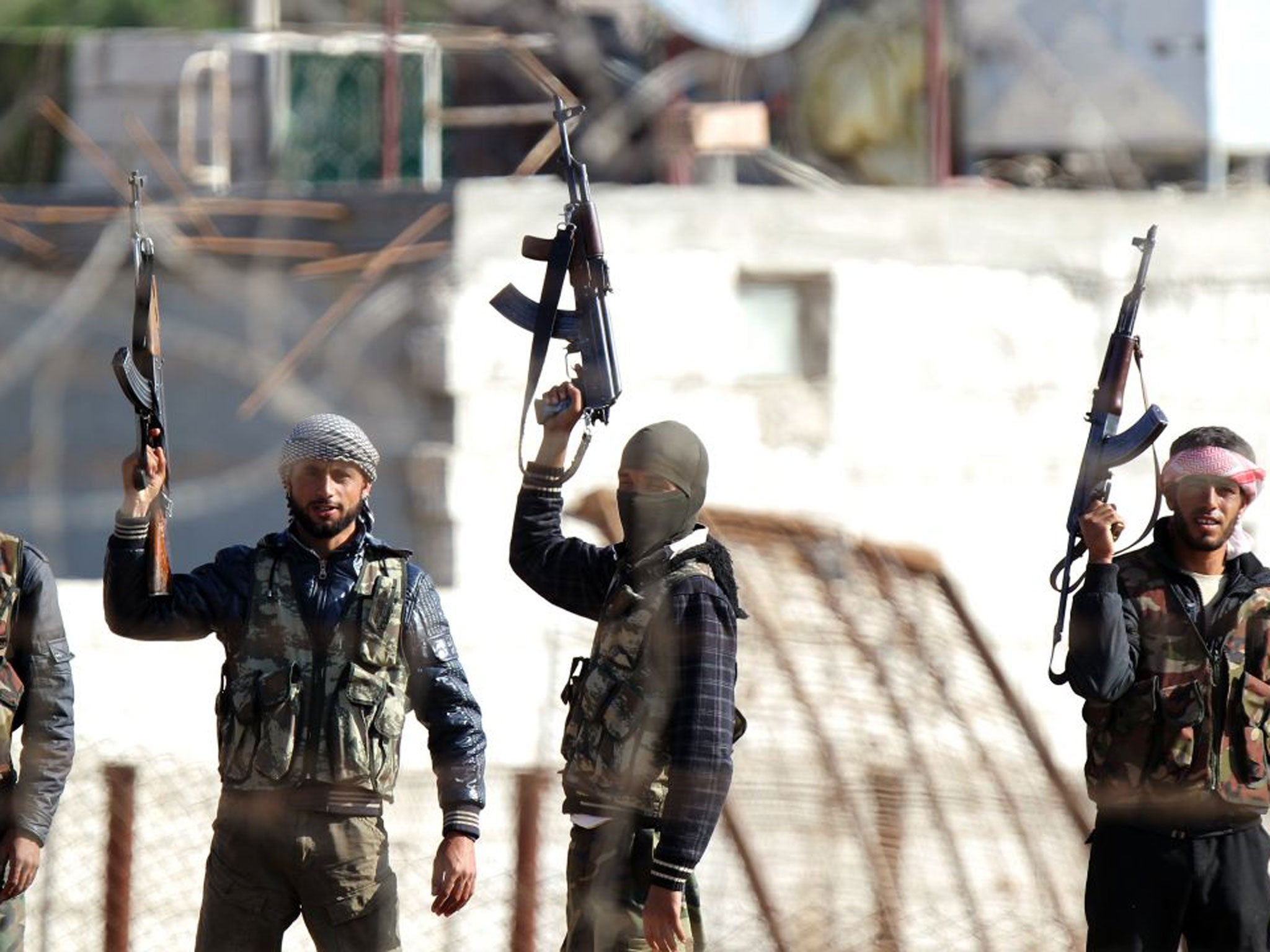 Syrian opposition fighters overrun a military post at Ras al-Ain on Wednesday. Below, French Foreign Minister Laurent Fabius