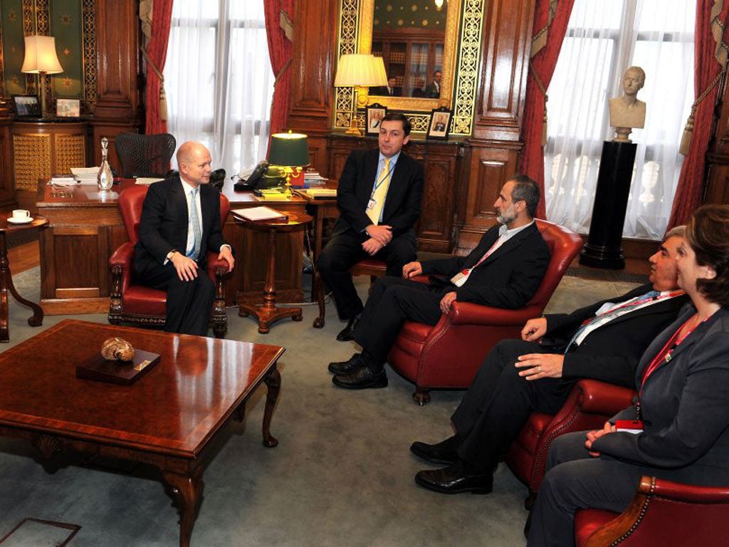 Foreign Secretary William Hague (left) talks to President Sheikh Ahmed Moaz Al-Khatib (third left) of the Syrian opposition movement