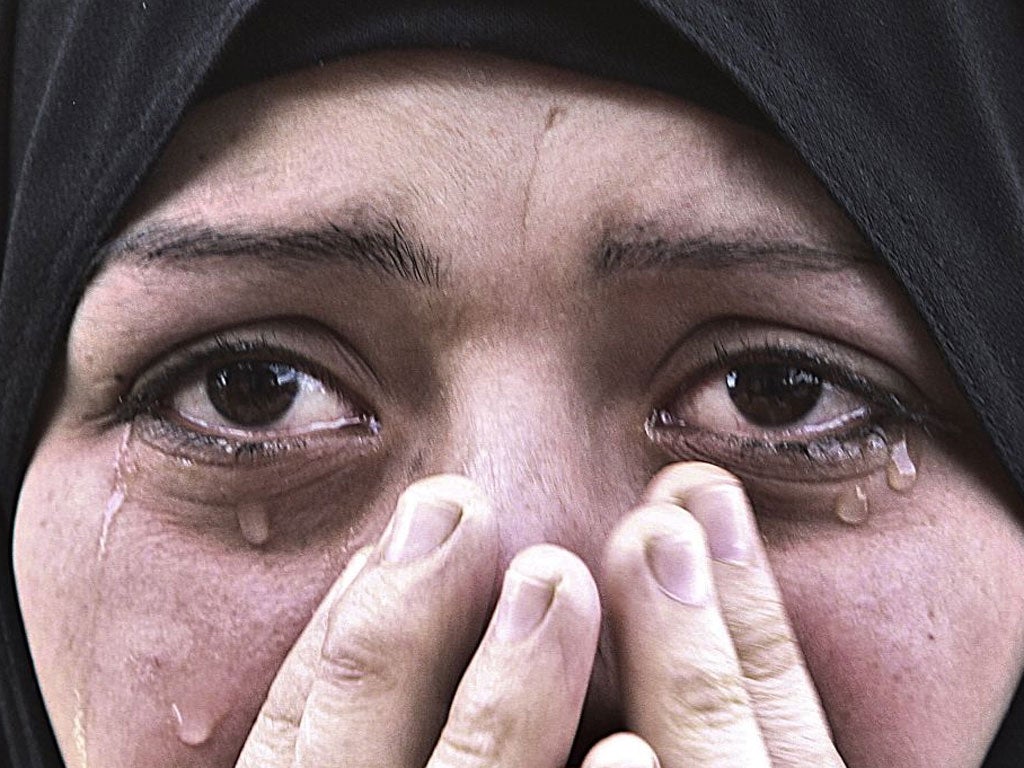 A woman cries during the funeral of her brother after he was killed in an Israeli air strike. Missiles continue to be fired on Israeli targets by Palestinian militant in the Gaza Strip