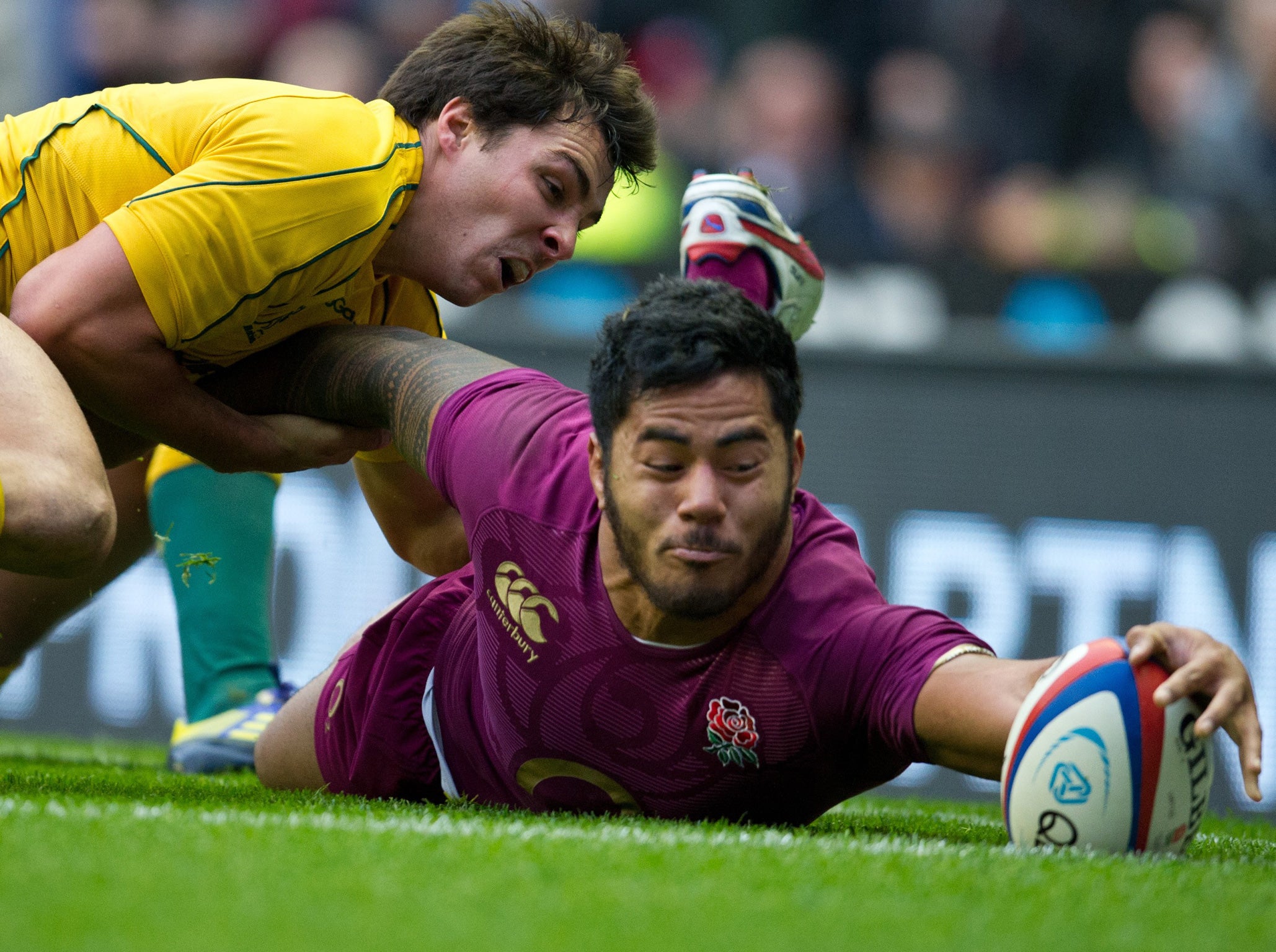 Manu Tuilagi inches the ball over the line for England’s one try against Australia yesterday