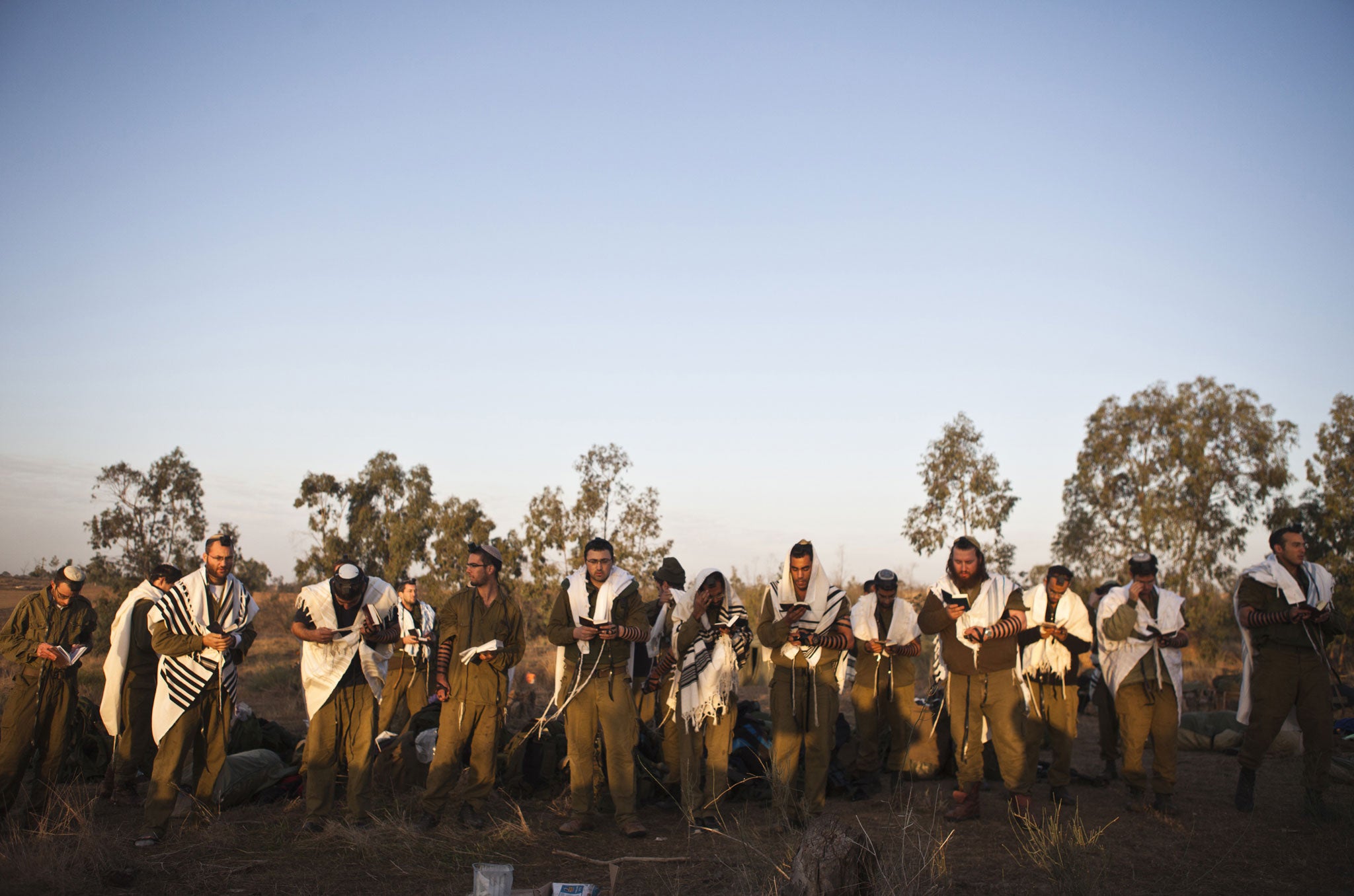 November 18, 2012: Israeli soldiers pray near the border with the central Gaza Strip. Israel bombed Palestinian militant targets in the Gaza Strip from air and sea for a fifth straight day on Sunday, preparing for a possible ground invasion while also spe