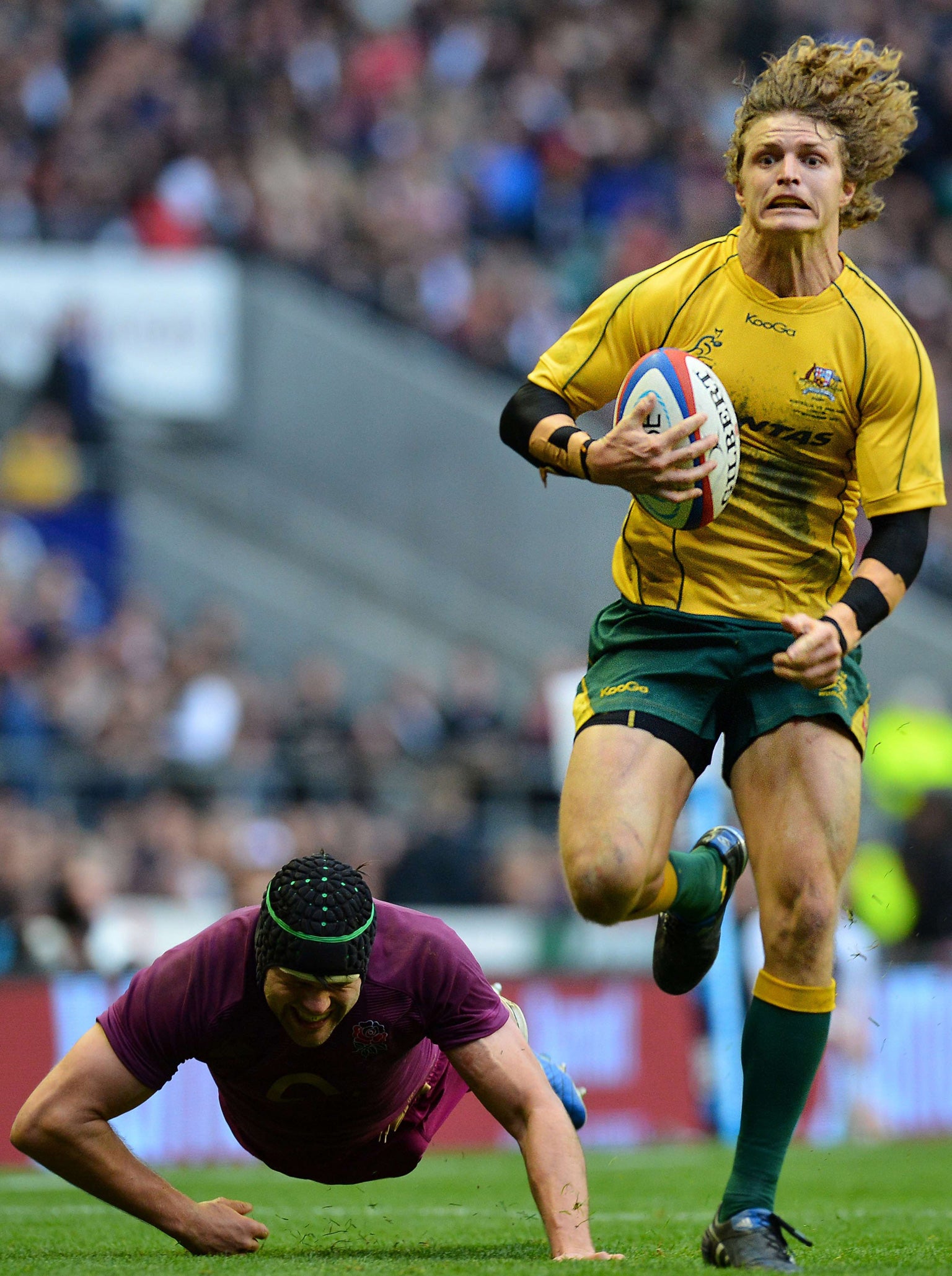 Flat out: Winger Nick Cummins leaves England’s Tom Palmer grounded as he runs in for Australia’s try