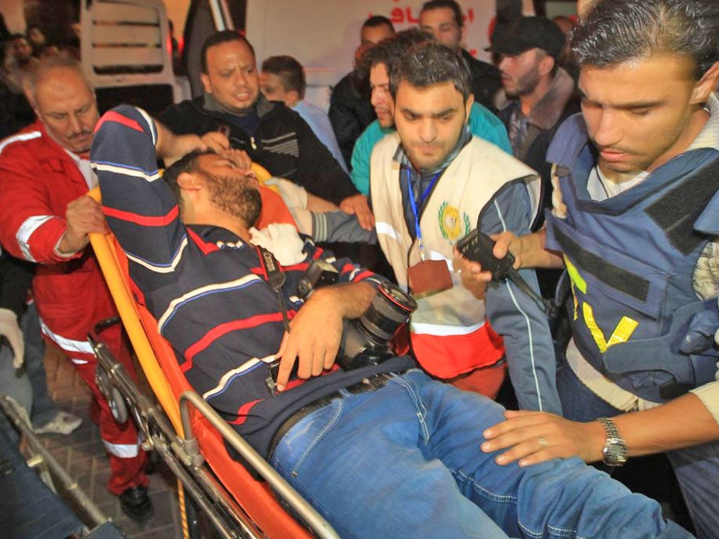 Medical staff treat a wounded Palestinian journalist in Gaza City yesterday