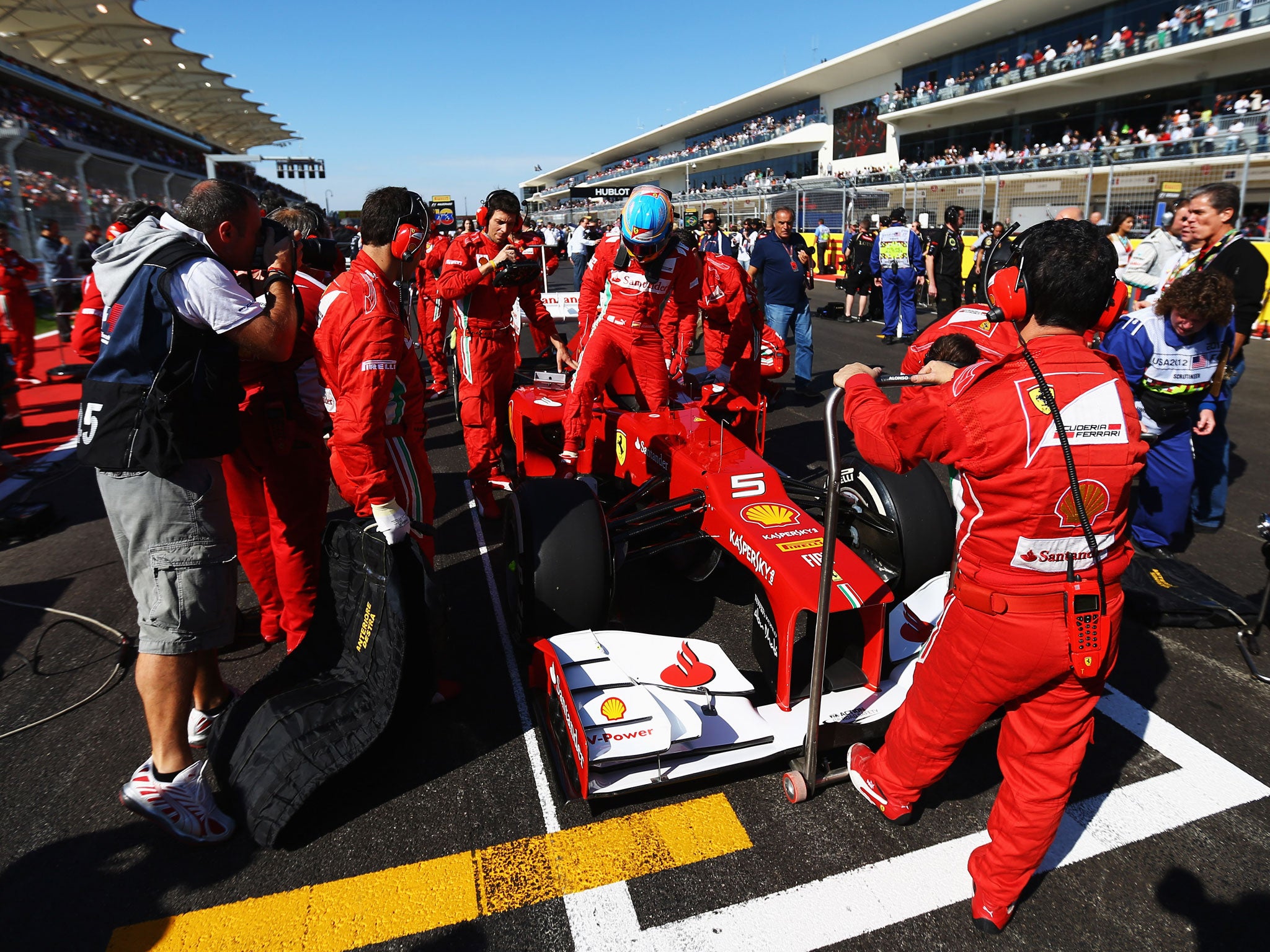 Fernando Alonso gets into his Ferrari ahead of the United States Formula One Grand Prix at the Circuit of the Americas