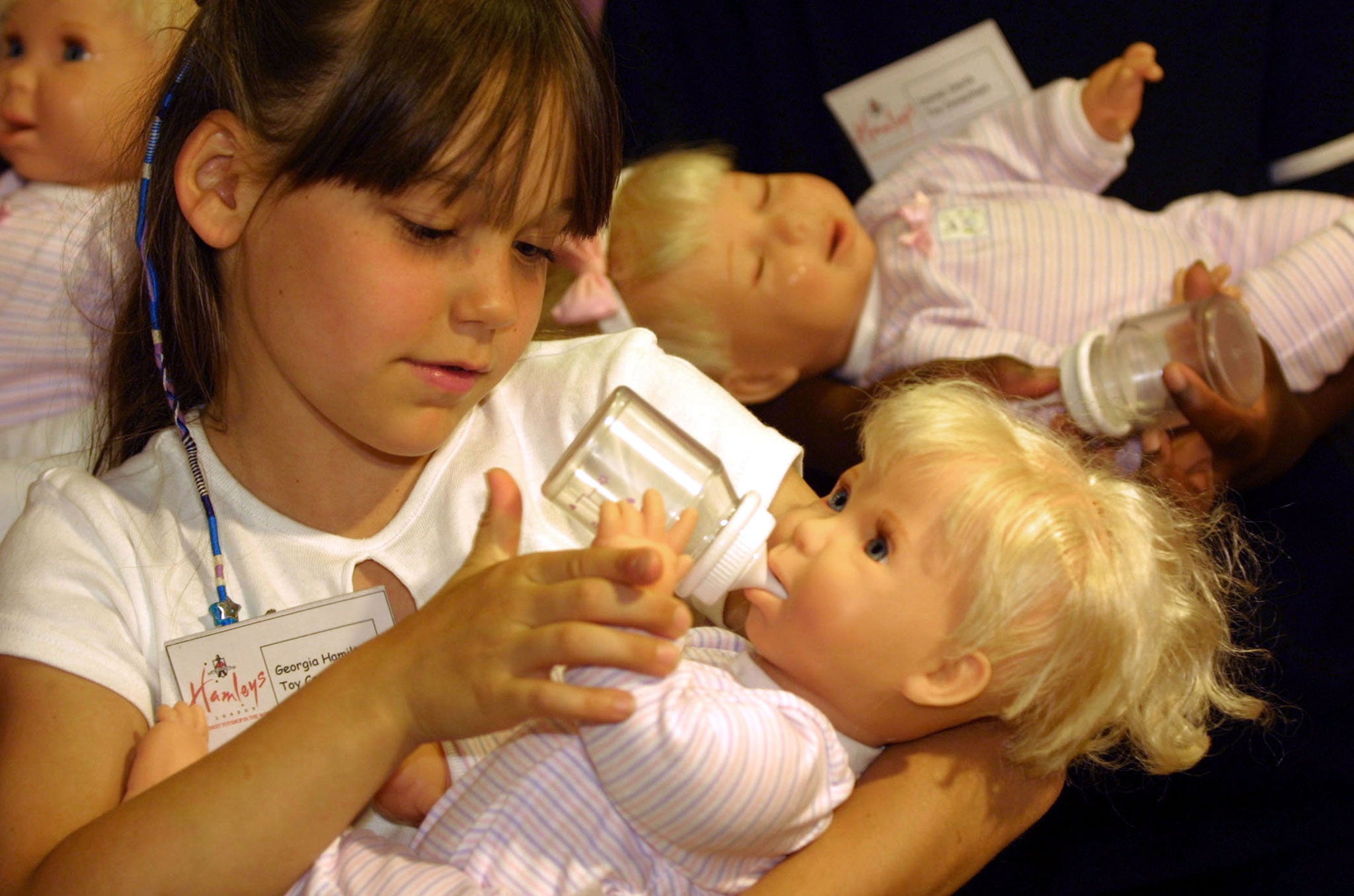 Georgia Hamilton, a Hamleys Store 'toy consultant,' tries out the new 'Miracle Baby' doll August 1, 2001 at the doll''s launch in London.